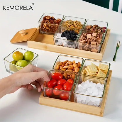 Set of 3 clear glass snack jars with bamboo wood lids arranged on wooden trays holding snacks and fruits