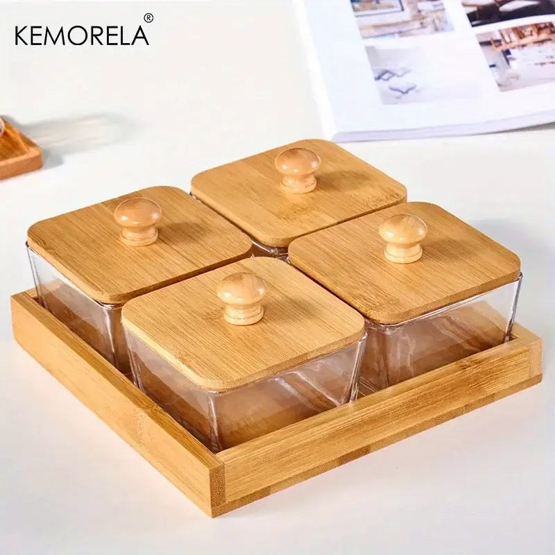 Set of four clear glass spice jars with bamboo wood lids and knobs in a matching bamboo wood tray