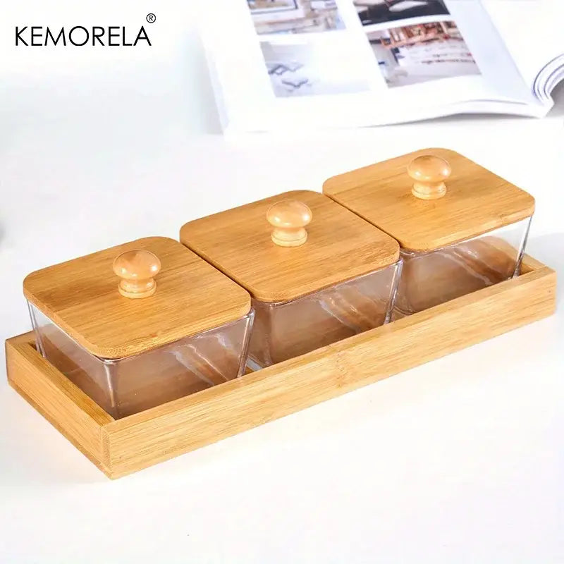 Set of three clear glass kitchen snack jars with bamboo wood lid and knobs in a matching bamboo wood tray