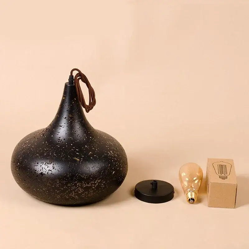 Set of 4 black and gold etched iron pendant light fixtures featuring a black speckled matte pendant light with brown cord