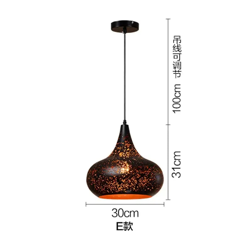 Set of 4 black and gold etched iron pendant light fixtures with dark brown speckled glass shade and orange glow