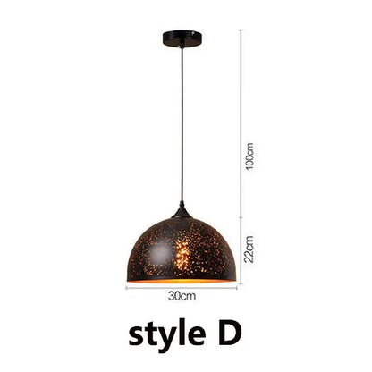 Set of 4 black and gold etched iron pendant light fixtures with speckled dome and orange interior glow for dining room