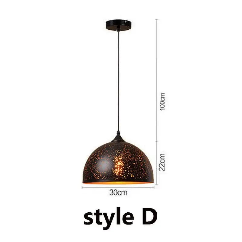Set of 4 black and gold etched iron pendant light fixtures with speckled dome and orange interior glow for dining room