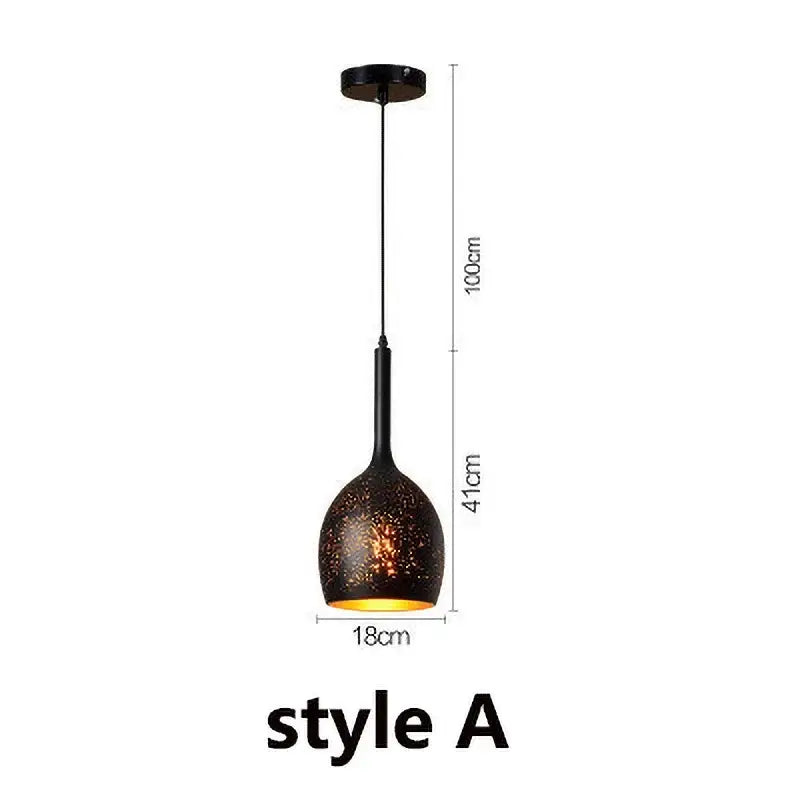 Set of 4 black and gold etched iron pendant light fixtures with textured speckled finish and warm amber glow