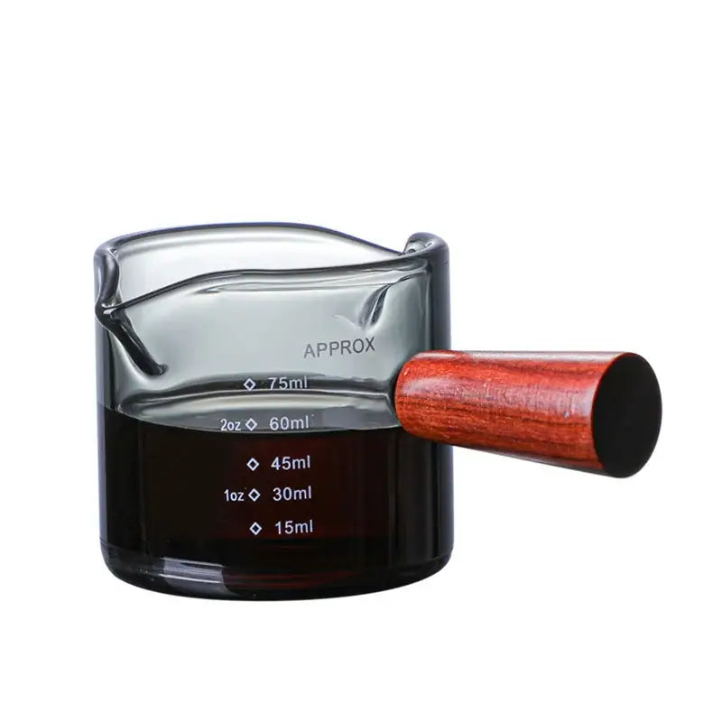 Clear glass measuring cup with polished reddish-brown wooden handle and graduated double mouth decorbites glass double markings