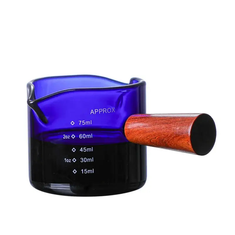A sleek cobalt blue decorbites glass double measuring cup with a polished wooden handle and engraved volume markings