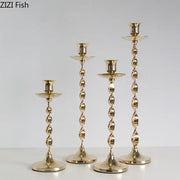 Set of 4 golden candlestick holders with twisted metal design and fluted bases for elegant dining room decorbites decor