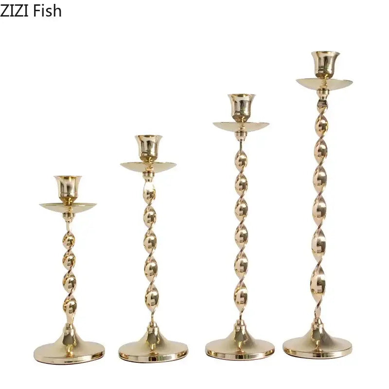 Set of 4 golden candlestick holders made of twisted metal with flared bases and matching saucers for dining room decorbites decor