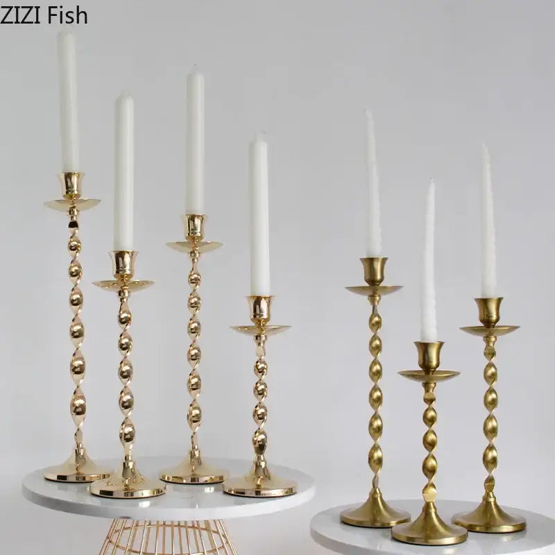Set of six elegant golden candlestick holders with twisted metal design and white taper candles for dining room decorbites decor
