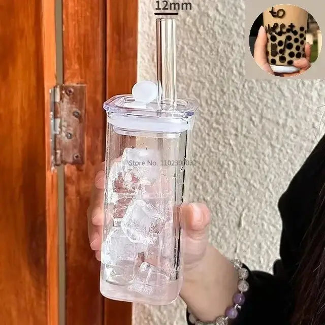 Clear plastic tumbler with white lid and silver straw filled with ice cubes featuring a colored handle layer