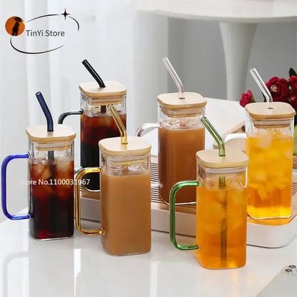 Set of 5 square glass mugs with colored handle layer and bamboo lids filled with iced beverages for kitchen use