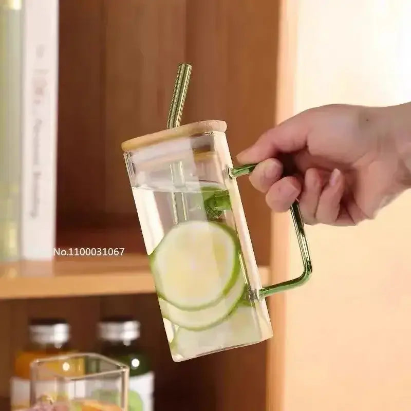 Set of 5 square glass mugs with colored handle layer featuring a clear glass mug with green handle and bamboo lid filled with cucumber water
