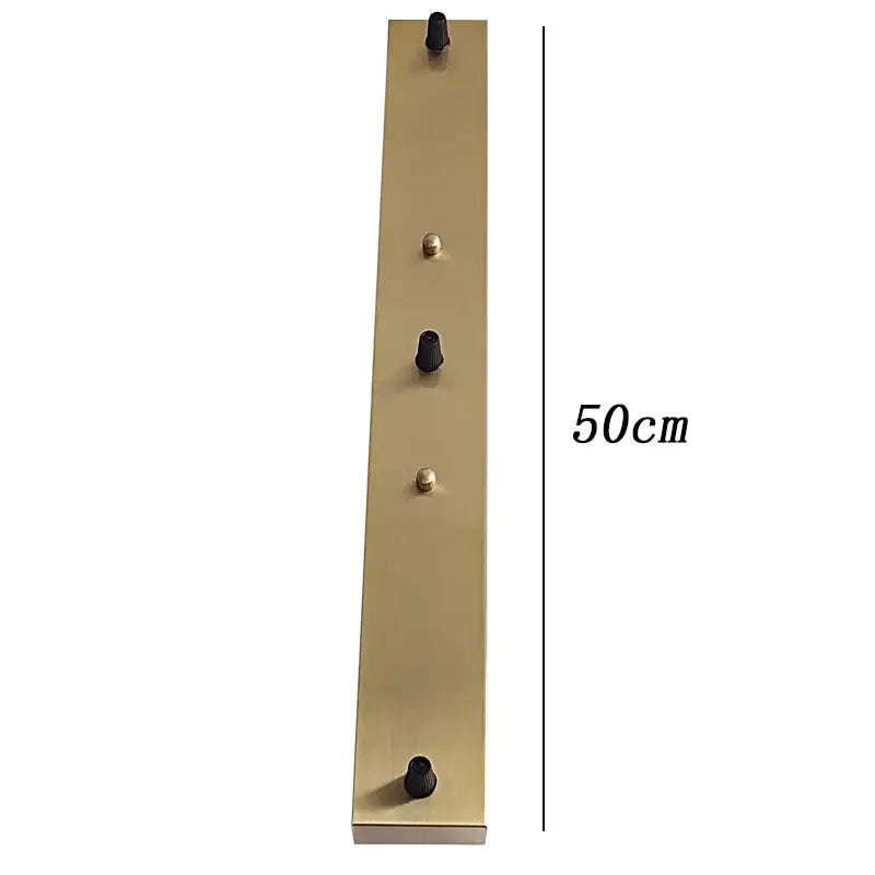 A sleek 50cm brass ceiling plate coat rack with five black plastic knobs suitable for lamp bases and diy kits