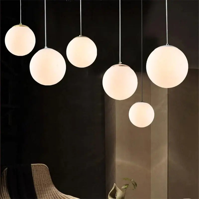 Set of five frosted glass ball pendant lights with slender metallic cords ideal for living room decorbites glass ball lighting