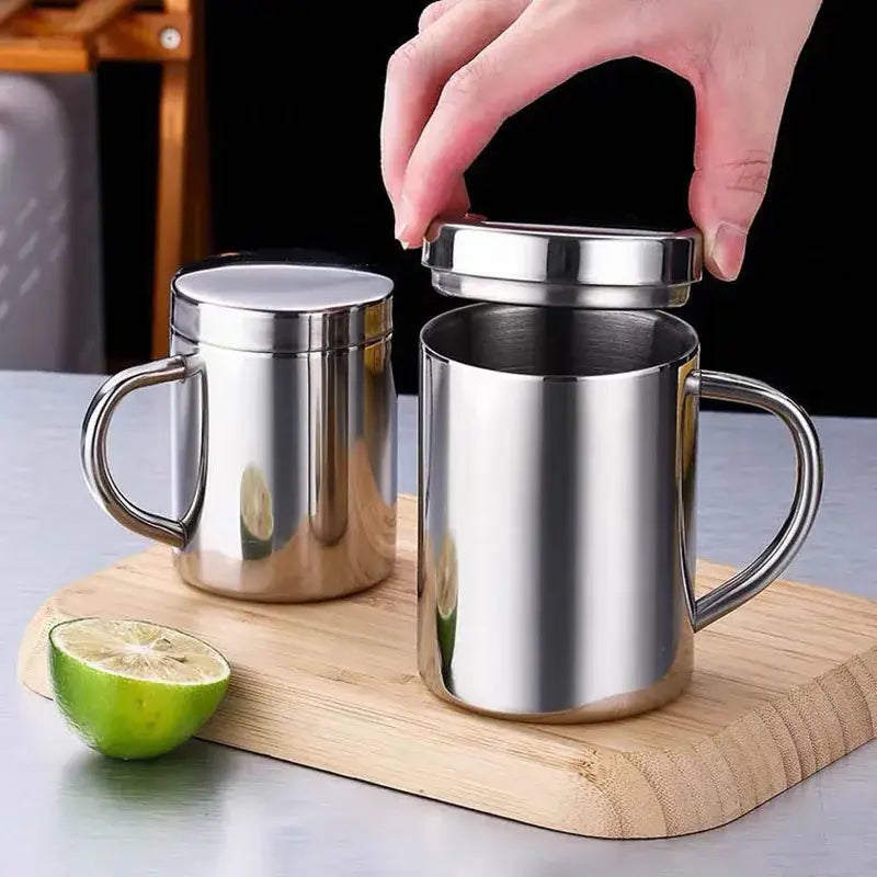 Shiny stainless steel double wall coffee mug with matching lid and handle designed for kitchen and travel use
