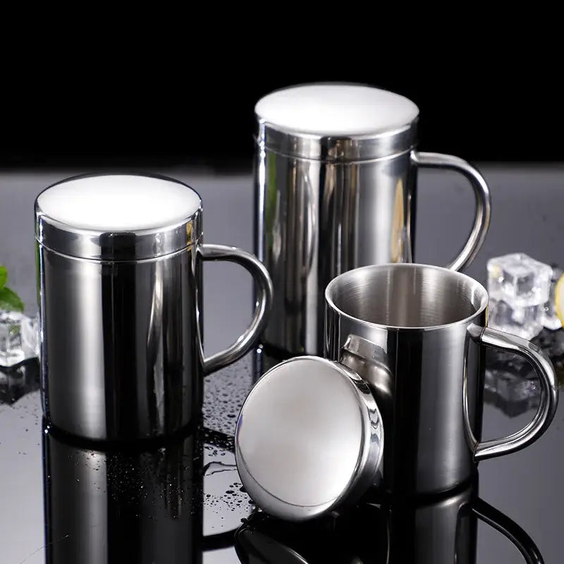 Shiny stainless steel double wall coffee mugs with lids and sturdy handles featuring a reflective finish for travel use