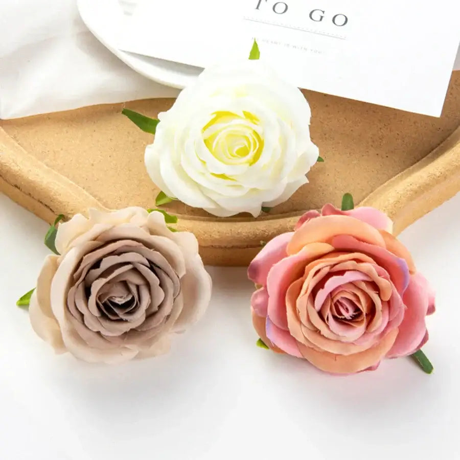 Three silk blue artificial flowers with cream white taupe and pink-orange layered petals for wedding decor