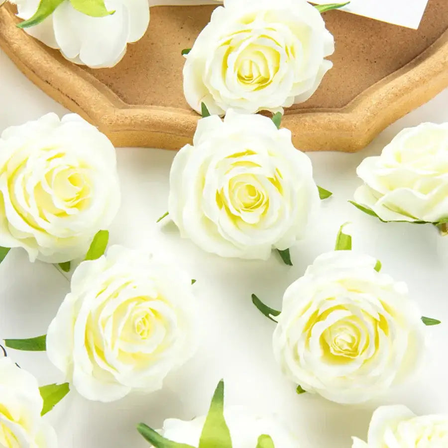 White artificial flowers with delicate yellow centers and green stems complement silk blue artificial flowers for decor