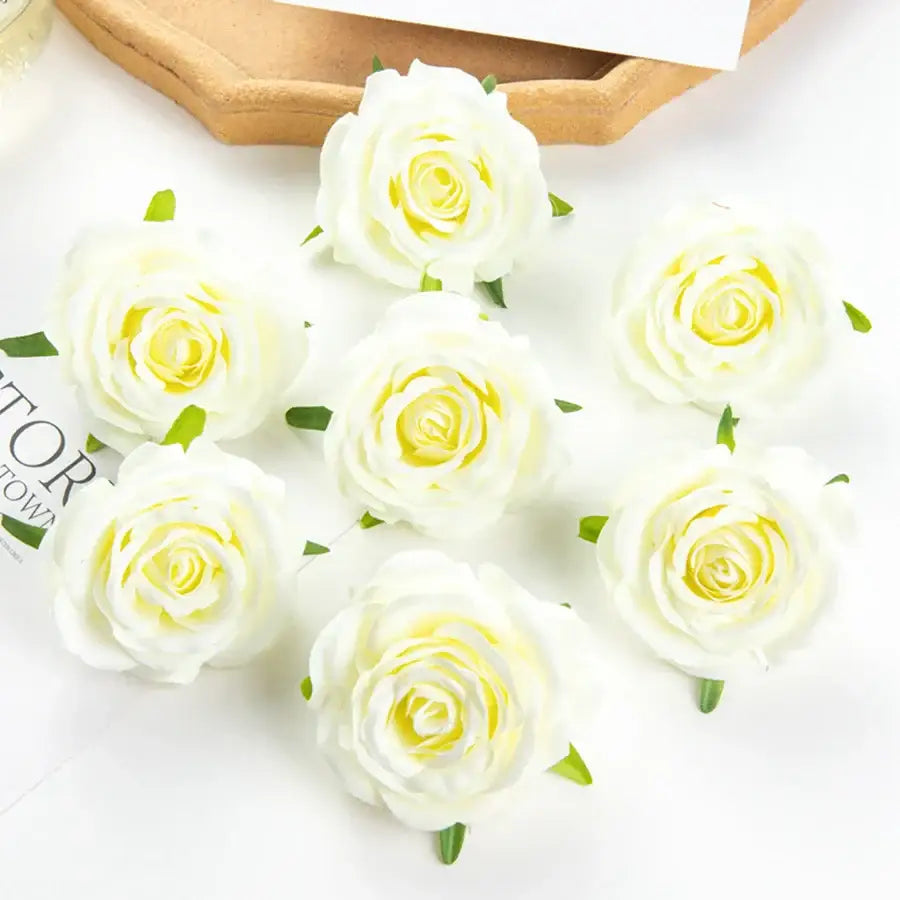 White artificial flowers with yellow centers and green leaves for silk blue rose wedding party decor and bedroom use