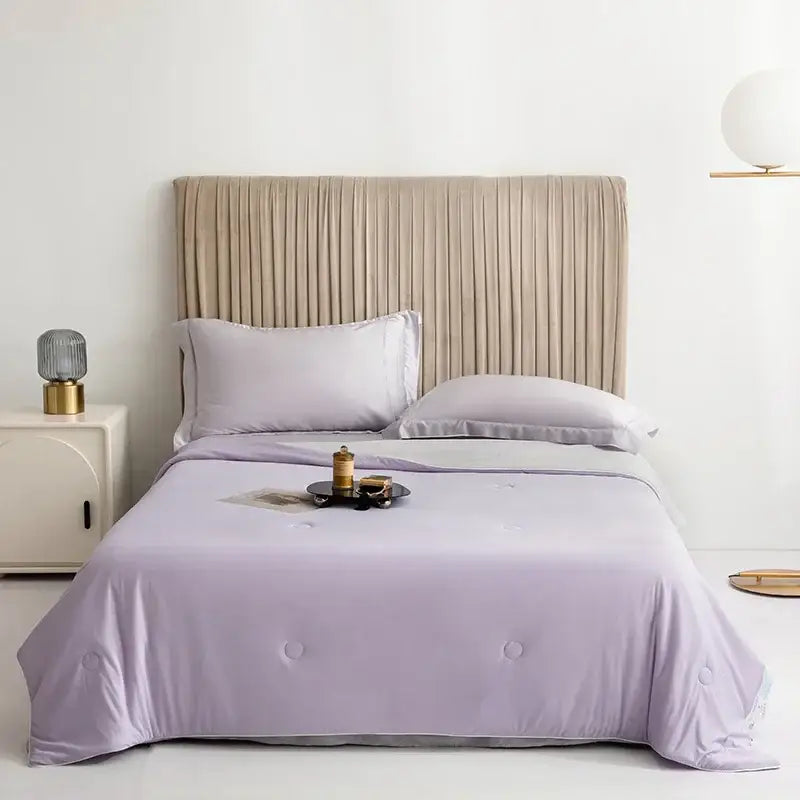Lavender-colored quilted cooling queen quilt with subtle button detailing for summer bedroom comfort