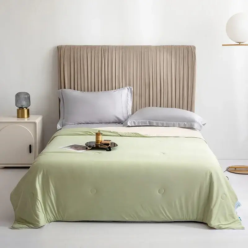 Soft mint green quilted bedspread with button detailing for a silky light blue cooling queen quilt summer comforter