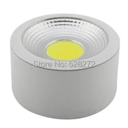 Silver cylindrical 15w cob led downlight with textured circular lens and bright yellow light for decorative lighting