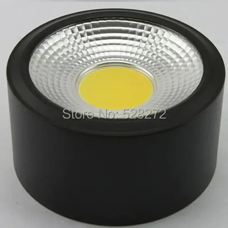 Black cylindrical 15w cob led downlight with textured silver reflector and central yellow light for decorative lighting