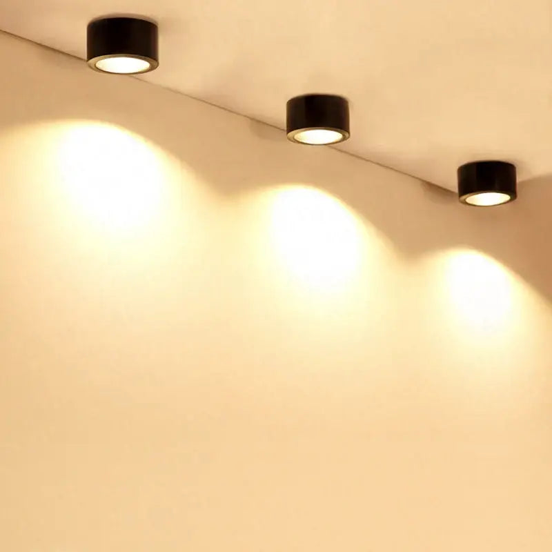 Three sleek black cylindrical 15w cob led downlights recessed for exhibition and decorative lighting emit warm illumination
