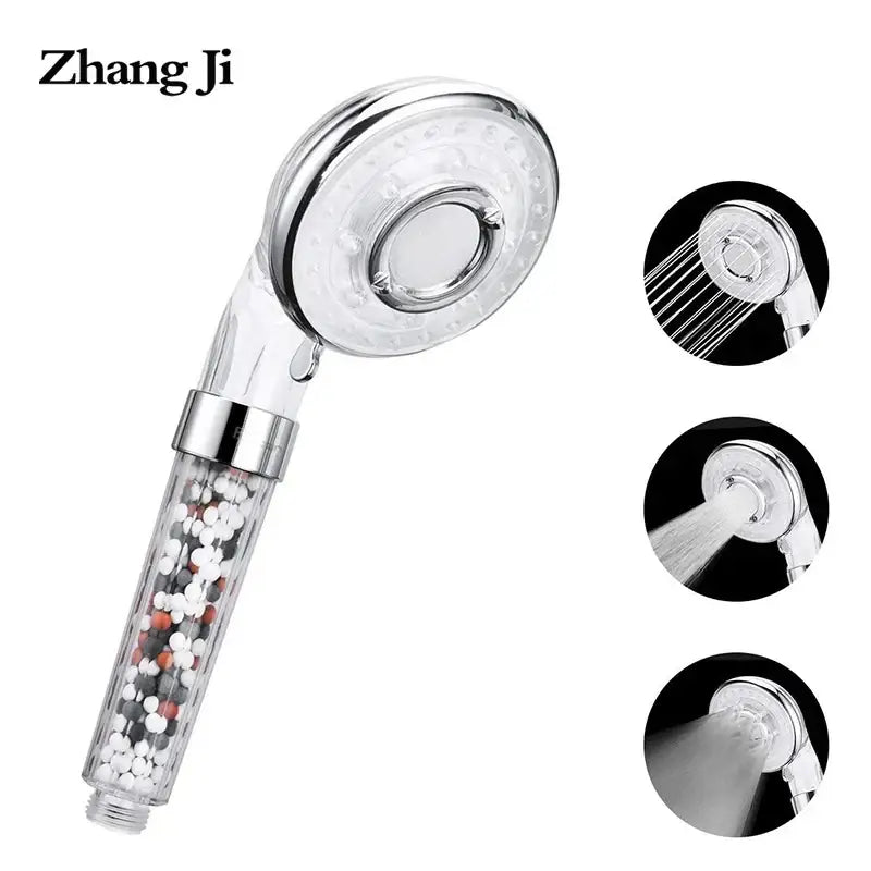 Silver and clear high pressure shower head with transparent filter housing containing white black and orange beads