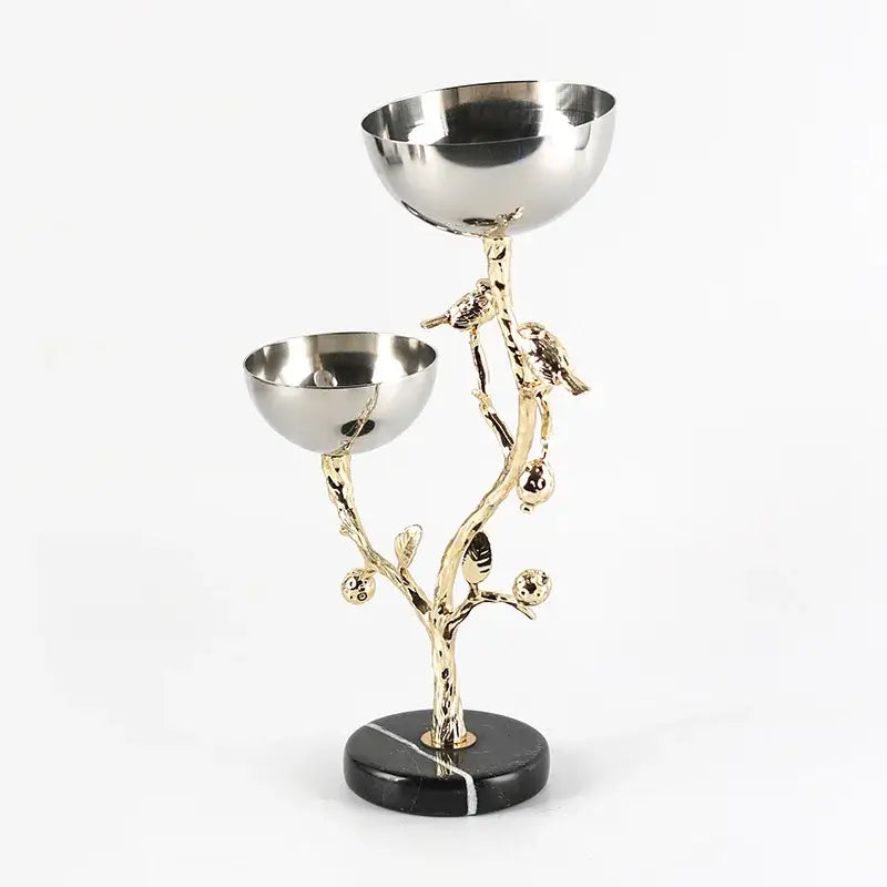 Elegant gold-toned metal snack bowl with tree design and birds on black marble base for dining room fruit stand