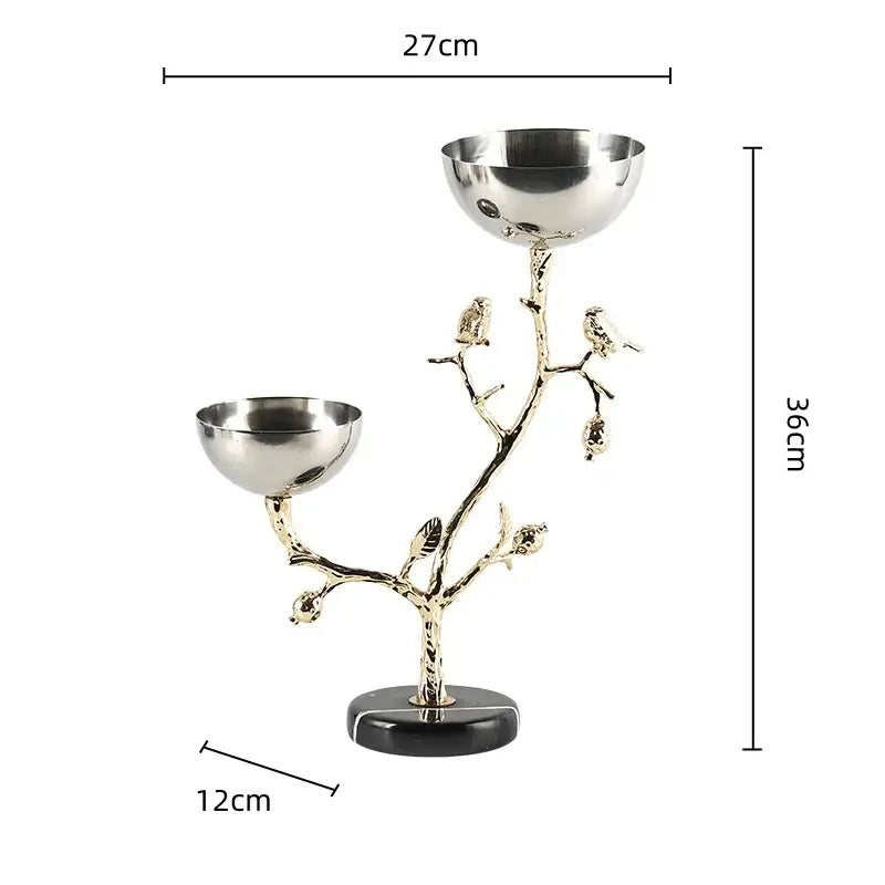 A sleek two-bowl metal snack bowl with gold bird branch design on black marble base for dining room use