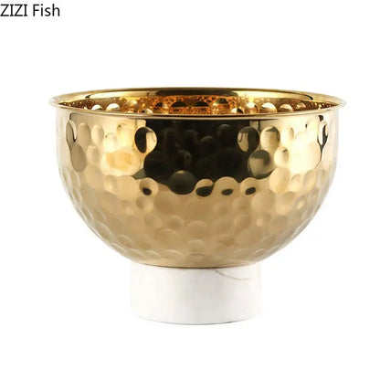 Gold-toned hammered metal fruits bowl with white marble base featuring hammer pattern for dining room pedestal tray