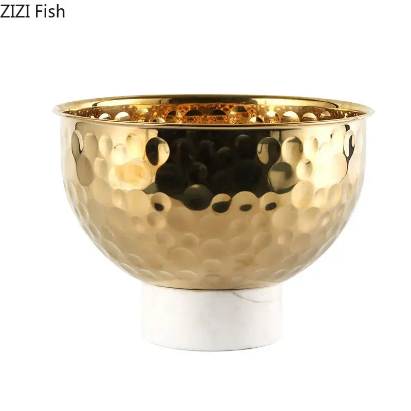 Gold-toned hammered metal fruits bowl with white marble base featuring hammer pattern for dining room pedestal tray