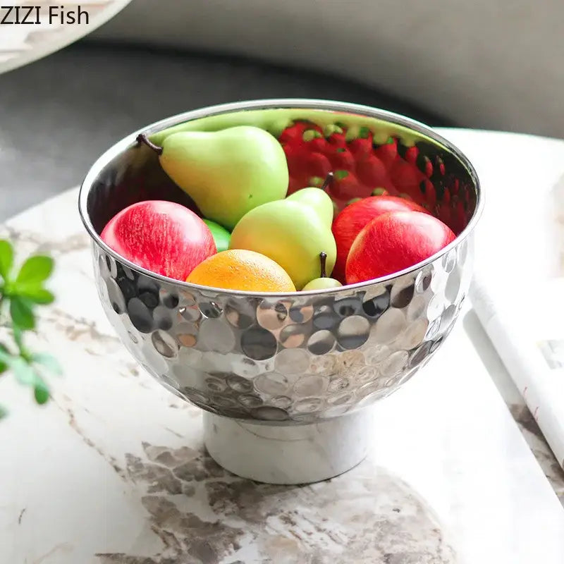 Shiny silver hammered metal fruits bowl with white marble base featuring a hammer pattern for dining room use