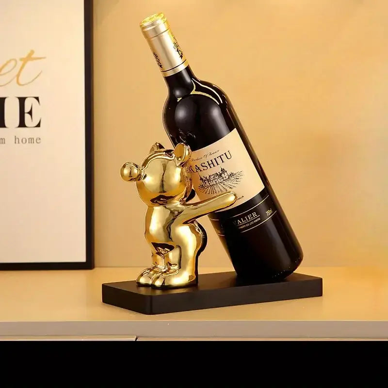 Silver and black bear wine rack with gold bear-shaped wine bottle holder in polished metallic finish for kitchen decor storage