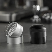 Silver and black decorbites coffee needle distributor with textured grips and fine metal tines for espresso stirring