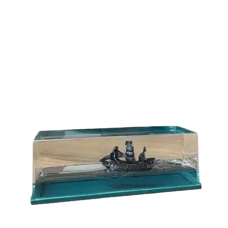A sleek silver black pearl pirate ship model with multiple sails in a glass display case office decorbites black pearl