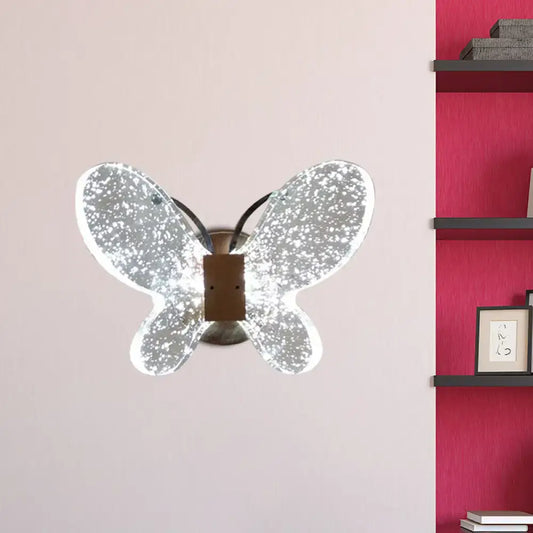 Silver butterfly crystal wall sconce with direct wired electric power source and mirrored glittery finish for bedroom use