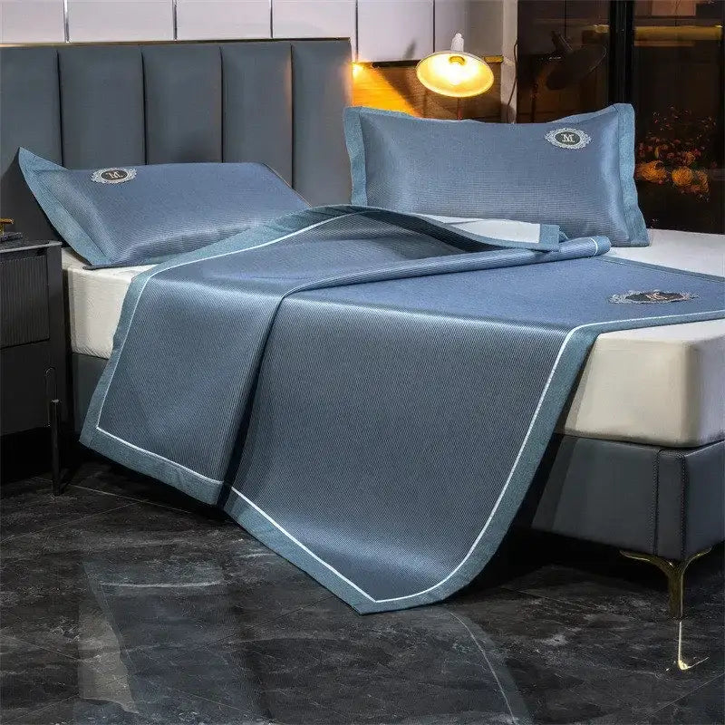 Blue textured breathable bed sheet with white piping and embroidered logo accents in decorbites carbon light cooling set