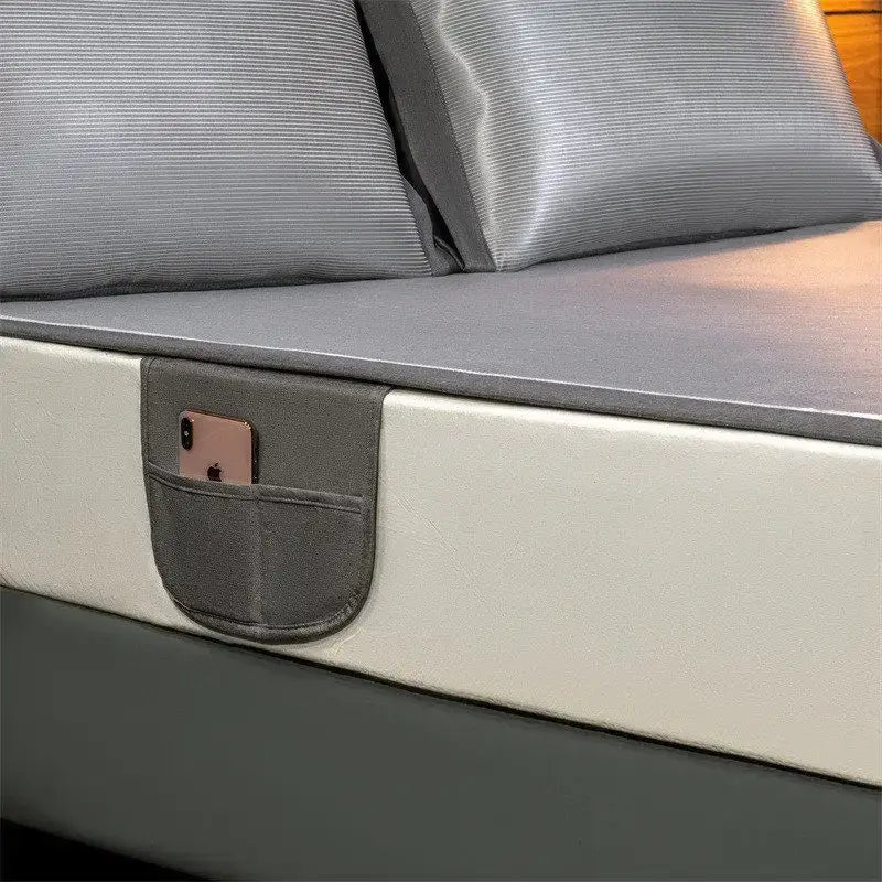 Gray fabric pocket attached to silver carbon light cooling mat bed frame holding a rose gold smartphone for decorbites carbon light