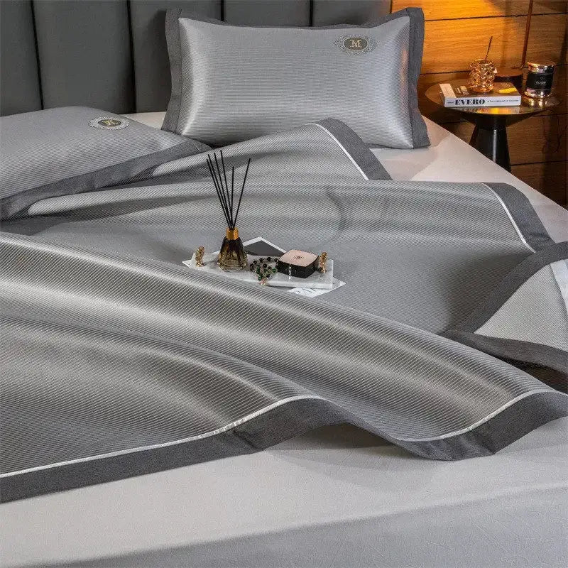 Silver-gray textured carbon light cooling bed set with subtle stripes and dark gray piping decorbites carbon light mat