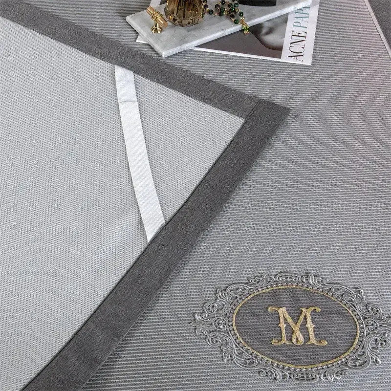 Gray striped decorbites carbon light cooling mat with silver embroidered monogram m for breathable bedroom use