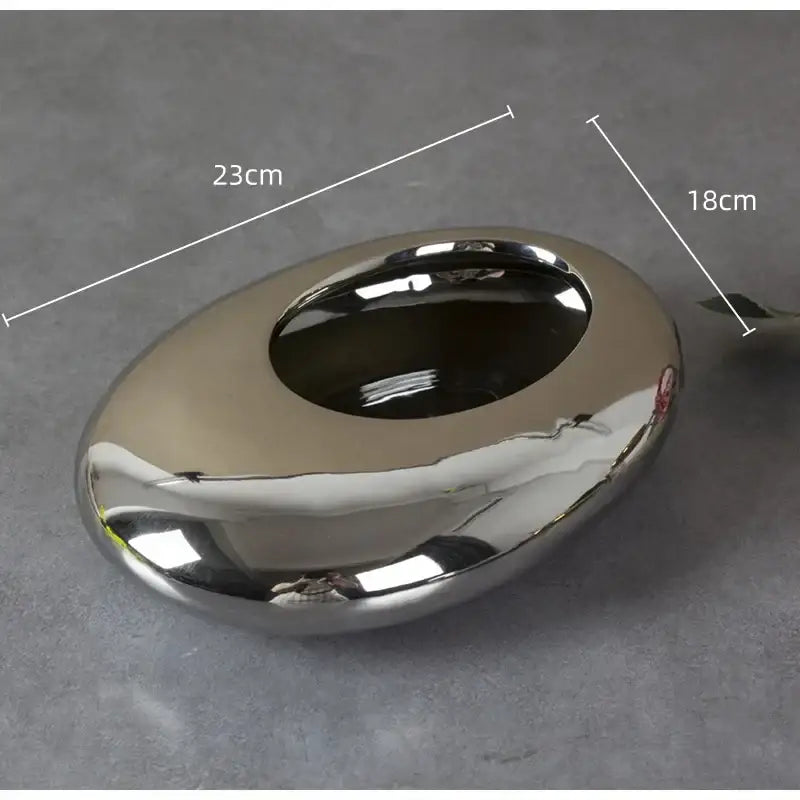 Shiny silver cobblestone ceramic oval ashtray with smooth reflective surface and rounded edges for decorbites living room decor
