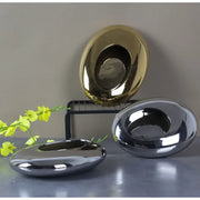Shiny metallic oval bowls in gold and silver finishes paired with decorbites silver cobblestone ceramic vase for living room decor
