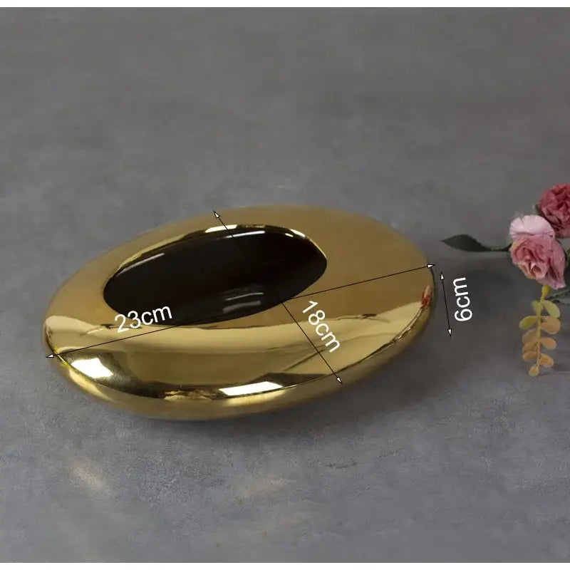 Shiny gold ceramic ashtray with smooth oval shape and dark interior from decorbites silver cobblestone ceramic bowl collection