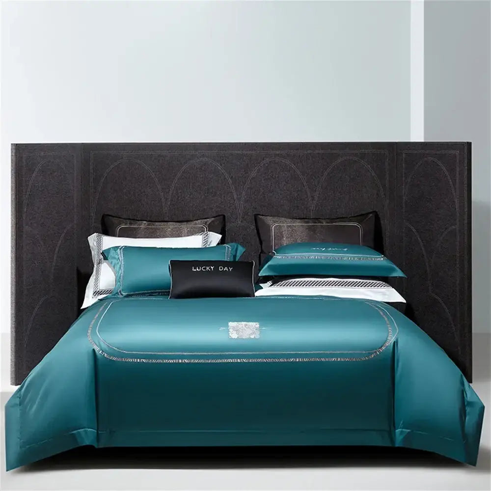Teal satin bedding set with silver embroidery and black accent pillow made of decorbites cotton satin jacquard fabric