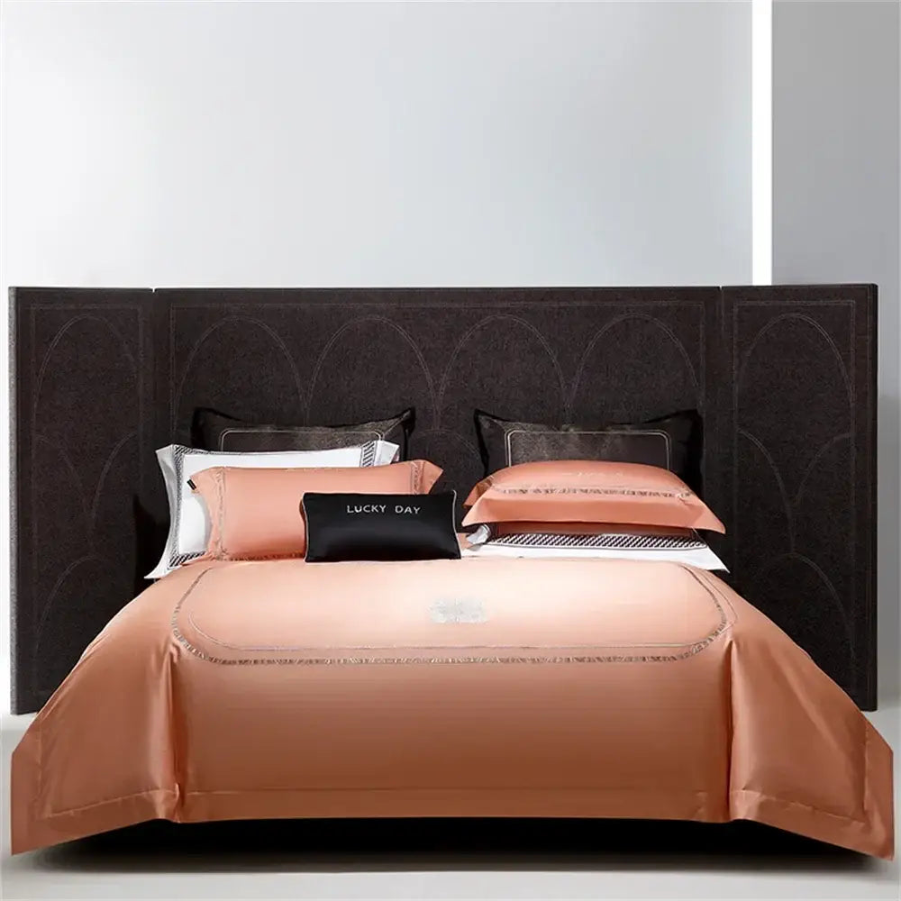 A luxurious peach-colored cotton satin jacquard bedding set with delicate silver thread trim for elegant decorbites decor