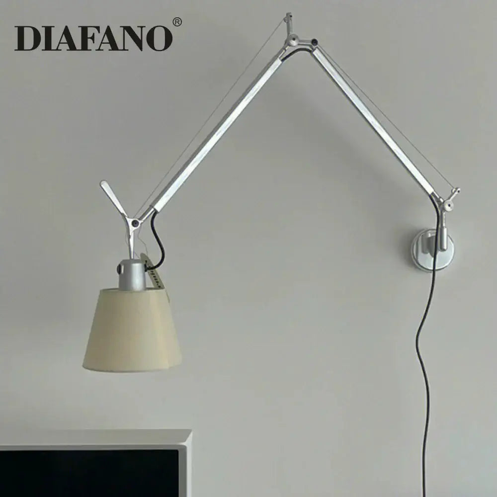 Silver and cream wall lamp with long swing arm and cream fabric shade for adjustable bedroom reading light decorbites