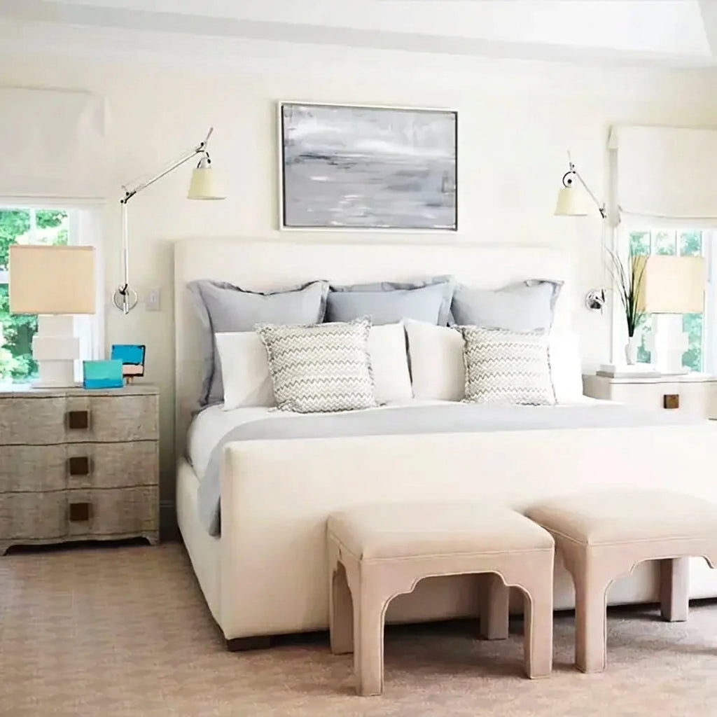 Cream-colored upholstered bed with tufted headboard and footstools paired with silver cream long swing arm wall lamp decorbites adjustable