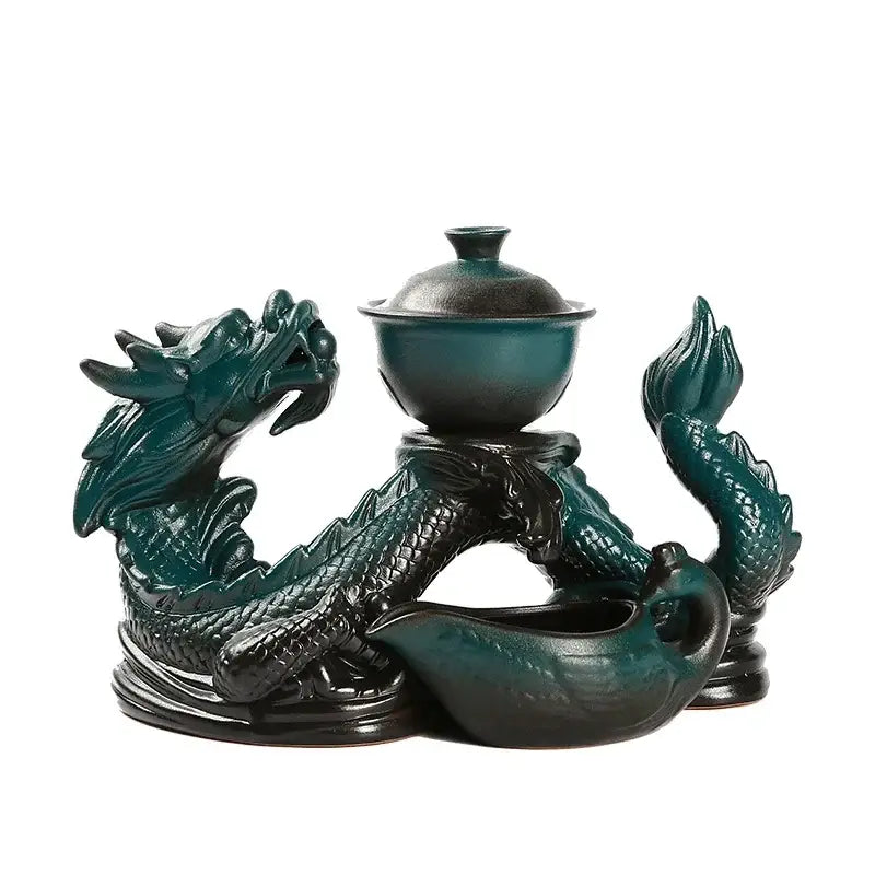 Dark teal ceramic decorbites dragon teapot on an intricately carved dragon stand in silver dragon ceramic tea set